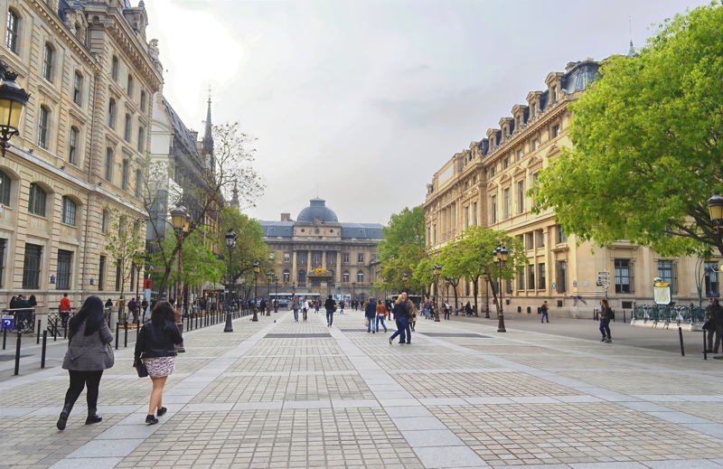 7 - A pedestrian view of the Palais de Justice and the surrounding historic stone buildings on the Île de la Cité in Paris, France